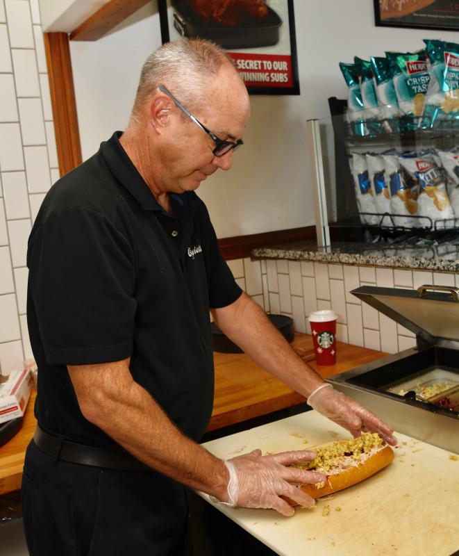Capriotti’s owner George Buchwald finishes up a Bobbie sandwich, which he can make in about one minute.